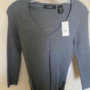 grey shirt with ties at bottom